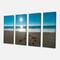 Designart - Blue Sea and Footprints in Sand - Large Seascape Art Canvas Print